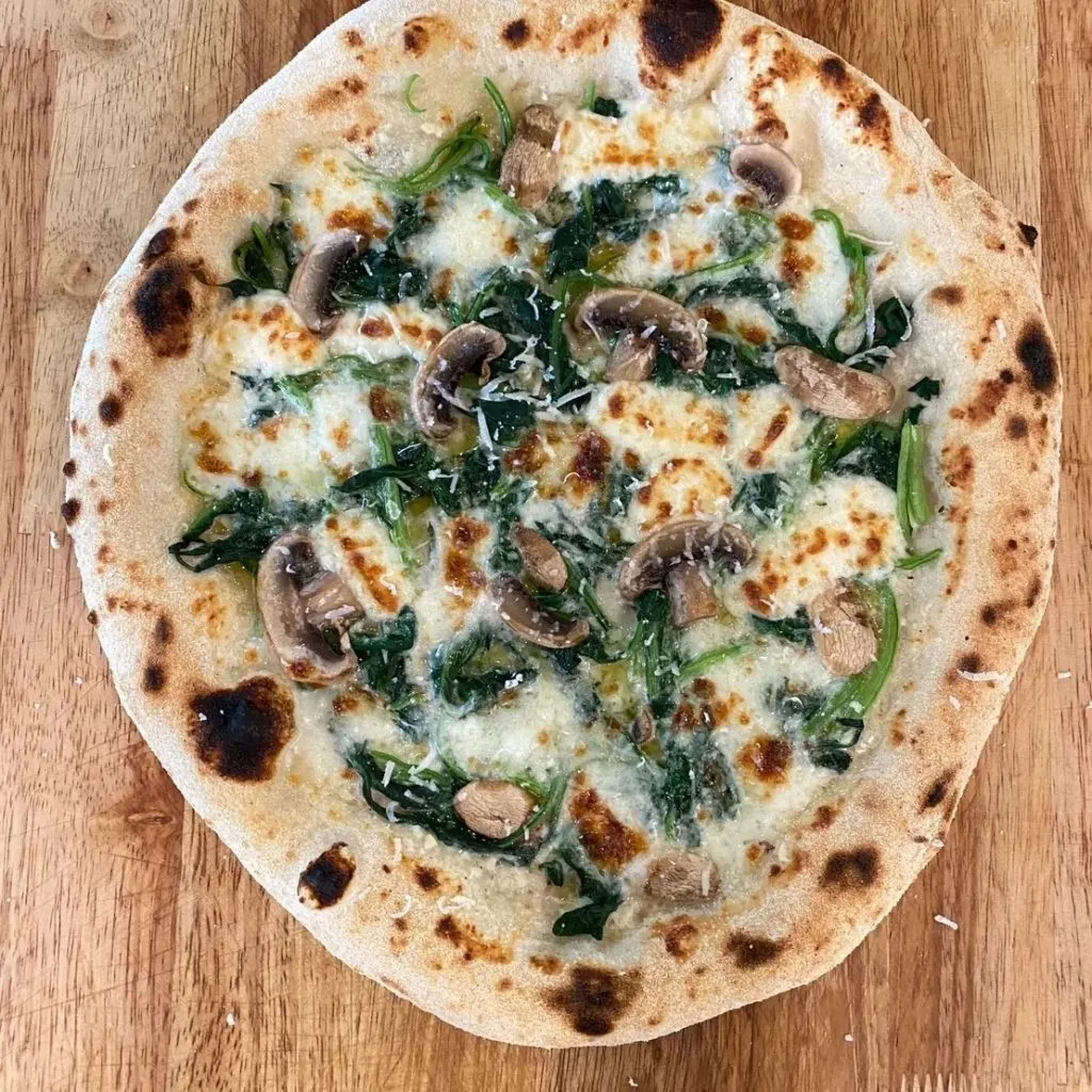 Pizza Glur & Bistro at Glur Hostel_Spinach and mushroom pizza. Garlic white sauce with mozzarella and grated parmesan with pesto splash for flavor.